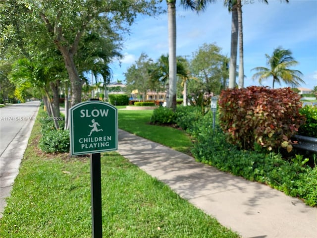 view of property's community with a yard