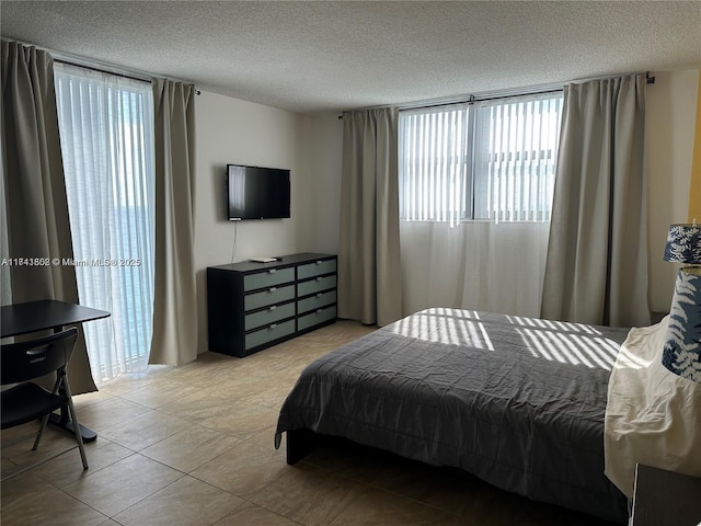 tiled bedroom featuring a textured ceiling