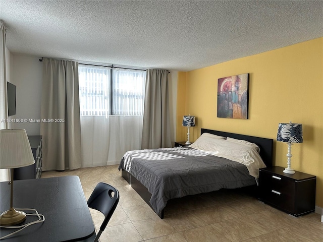 bedroom with light tile patterned flooring and a textured ceiling