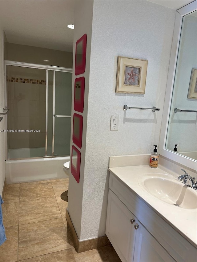 full bathroom featuring tile patterned flooring, vanity, combined bath / shower with glass door, and toilet