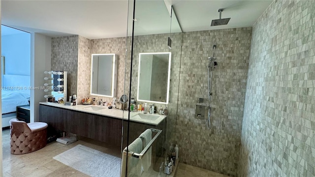 bathroom featuring tiled shower and vanity