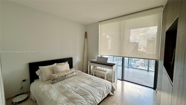 bedroom with expansive windows and access to outside