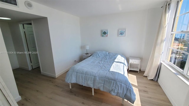 bedroom with light hardwood / wood-style floors