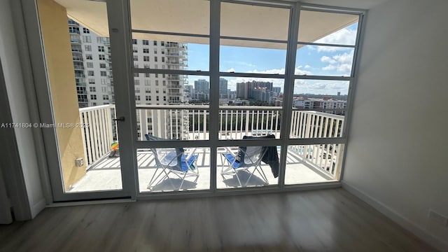 interior space with hardwood / wood-style flooring and a wall of windows