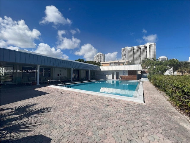 community pool featuring a city view and a patio area