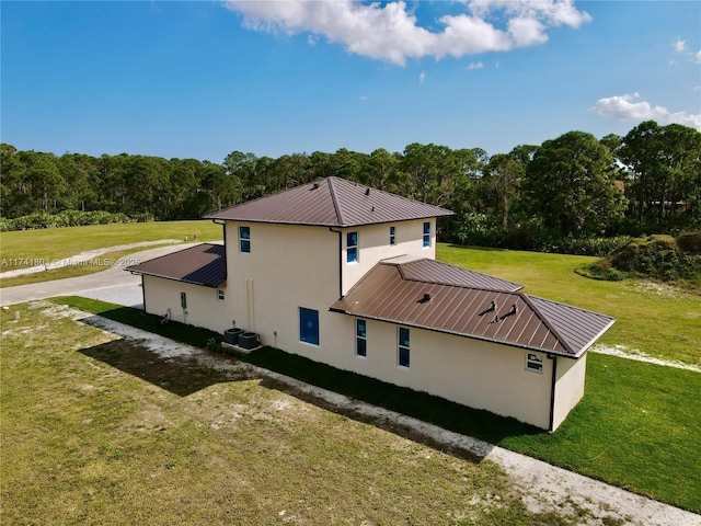 view of property exterior featuring a yard and central AC