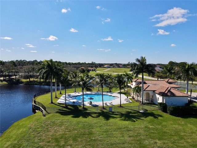 view of pool featuring a water view and a yard