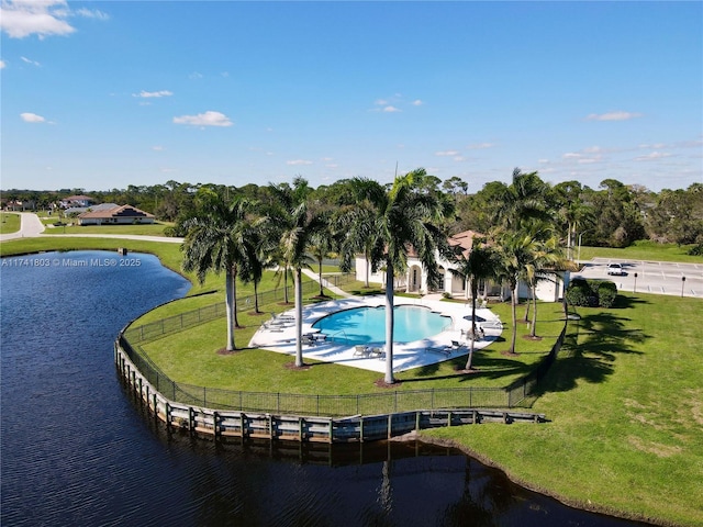 exterior space featuring a water view, a pool, and a yard