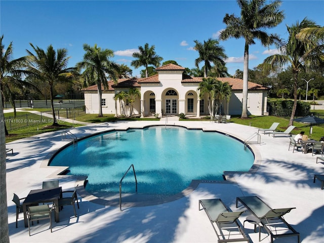 view of pool with a yard and a patio