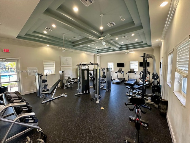 gym with ceiling fan, ornamental molding, and a raised ceiling