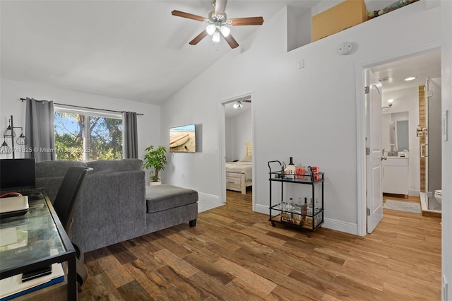 living room featuring ceiling fan, high vaulted ceiling, and hardwood / wood-style floors