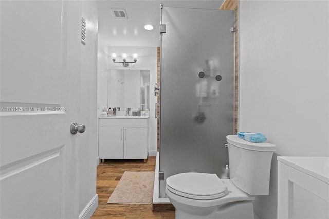 bathroom featuring hardwood / wood-style flooring, vanity, and toilet