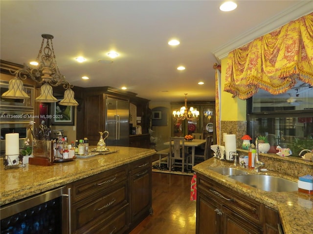 kitchen featuring pendant lighting, sink, stainless steel built in refrigerator, wine cooler, and dark hardwood / wood-style flooring