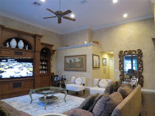 living room featuring crown molding, dark wood-type flooring, ceiling fan, and a high ceiling