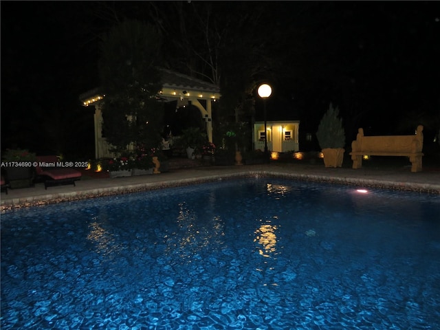 view of pool at night