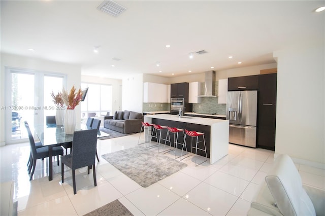 dining room featuring sink and light tile patterned floors