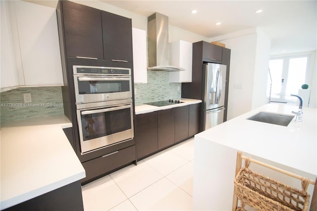 kitchen featuring light tile patterned flooring, sink, white cabinets, exhaust hood, and stainless steel appliances