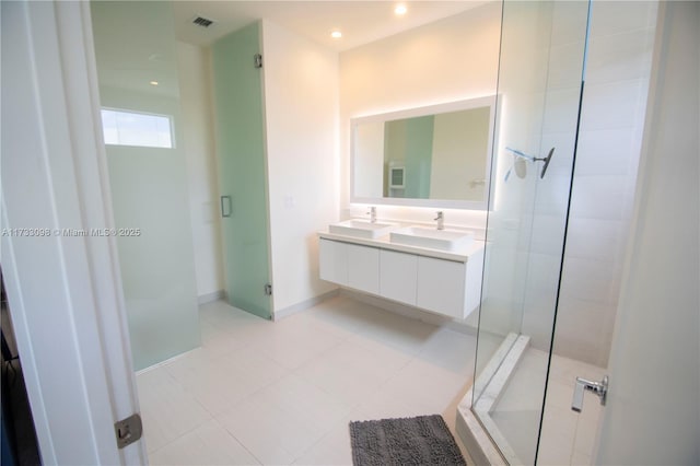 bathroom featuring tile patterned flooring, vanity, and a shower with shower door