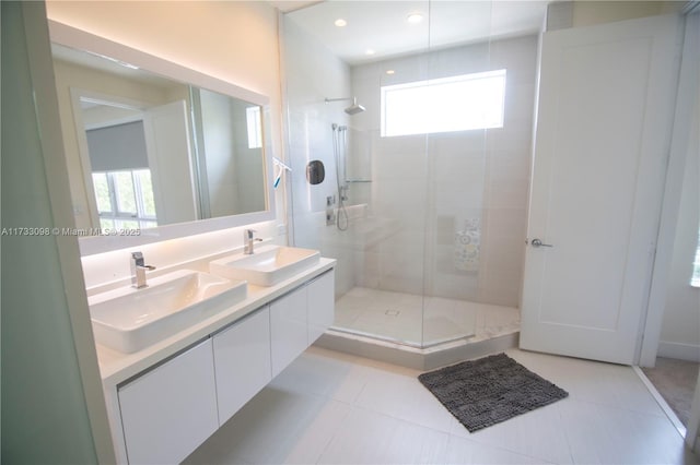 bathroom with tile patterned flooring, vanity, and a shower with shower door