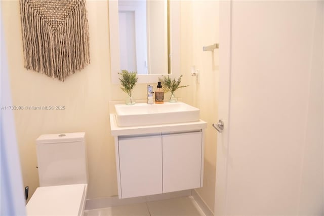 bathroom with vanity, tile patterned floors, and toilet