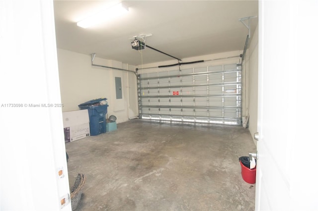 garage featuring a garage door opener and electric panel