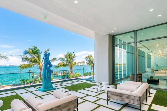 balcony featuring outdoor lounge area and a water view