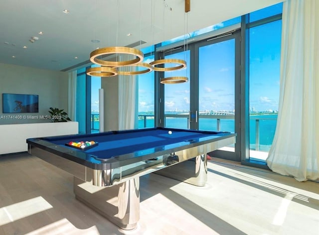 rec room featuring a water view, a wall of windows, and pool table