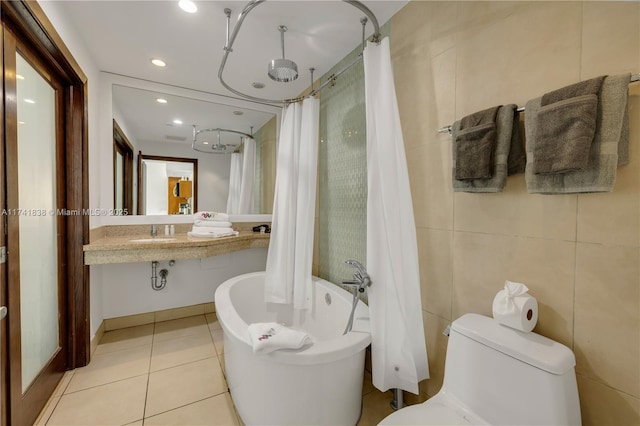 full bathroom featuring toilet, sink, tile walls, shower / bath combination with curtain, and tile patterned flooring