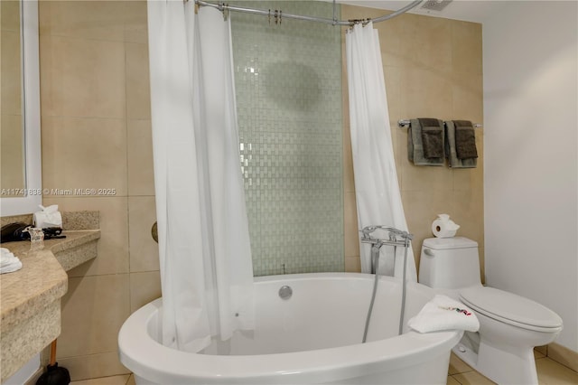 bathroom featuring toilet, tile patterned flooring, shower / tub combo, and tile walls