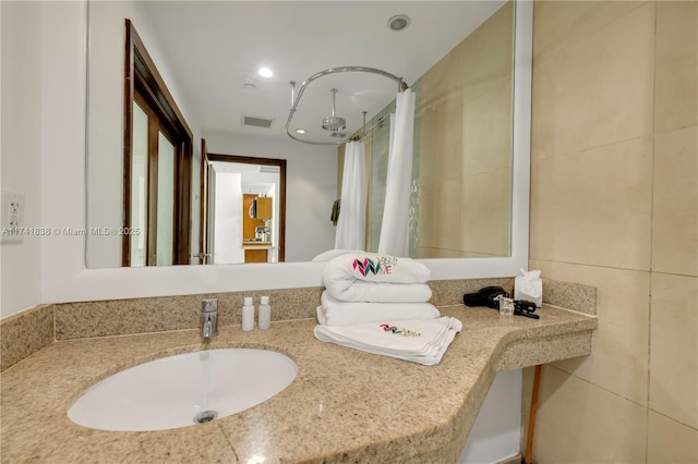 bathroom featuring sink and curtained shower