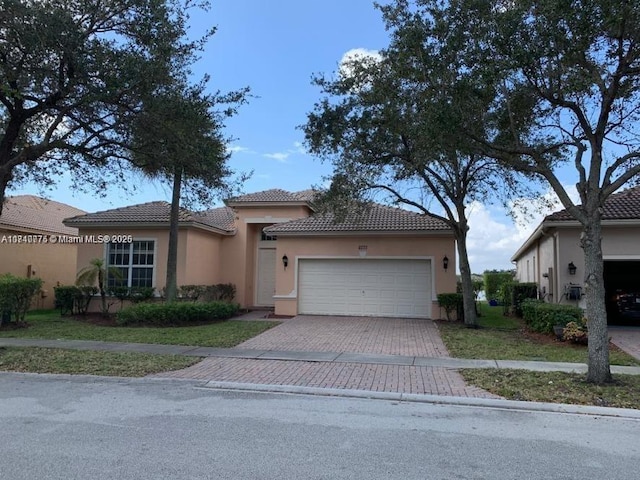 mediterranean / spanish-style home with a garage and a front yard