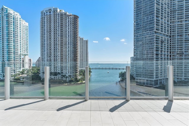 exterior space featuring floor to ceiling windows and a water view