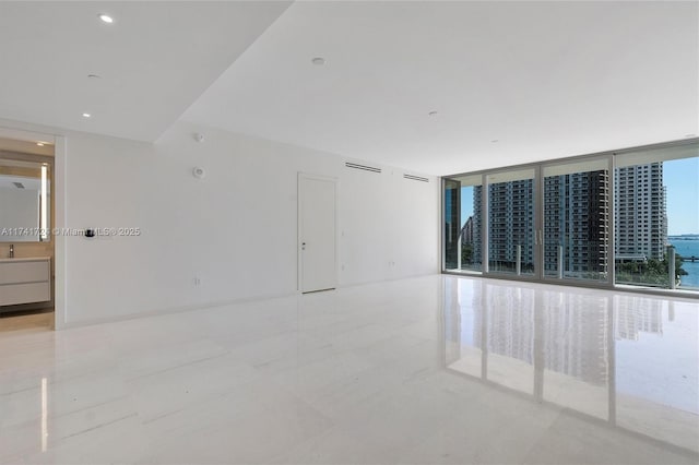 spare room with floor to ceiling windows