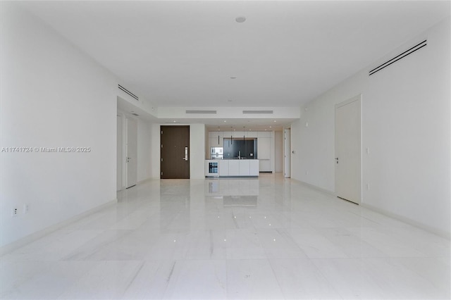 unfurnished living room with sink