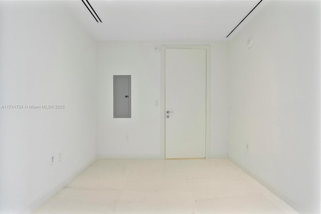 unfurnished room featuring electric panel