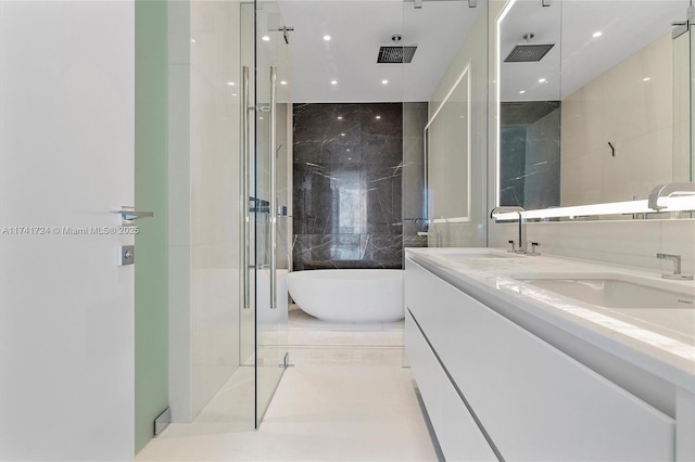 bathroom with vanity, tile patterned flooring, independent shower and bath, and tile walls