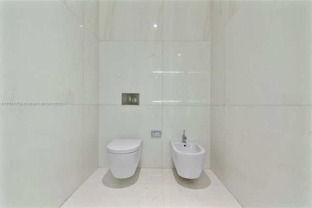 bathroom featuring a bidet, toilet, and tile patterned flooring