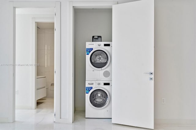 laundry room with stacked washing maching and dryer