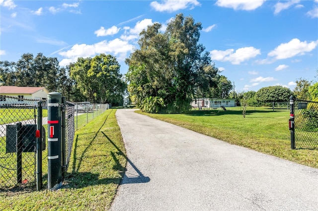 1601 SW 117th Ave, Davie, FL 33325 - view of street featuring a gated entry, a gate, and aphalt driveway