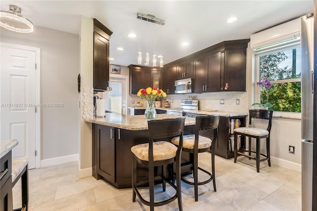 1601 SW 117th Ave, Davie, FL 33325 - kitchen featuring a wall mounted AC, light stone counters, a peninsula, backsplash, and stainless steel appliances