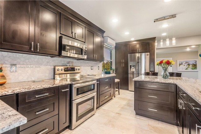 1601 SW 117th Ave, Davie, FL 33325 - kitchen featuring dark brown cabinetry, a wall mounted AC, light stone counters, stainless steel appliances, and backsplash