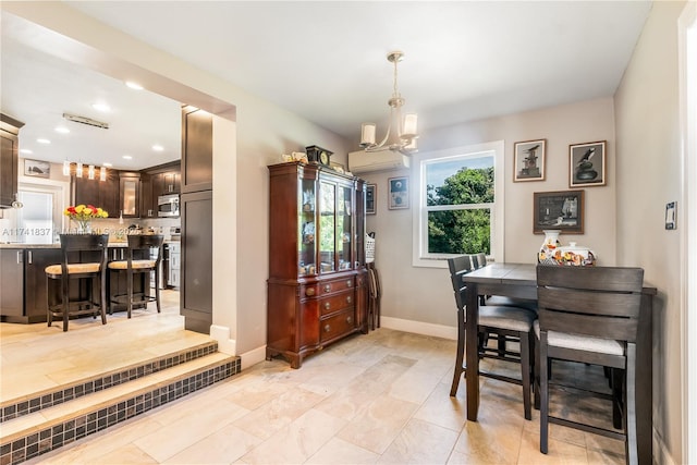 dining room with a wall mounted AC and a chandelier