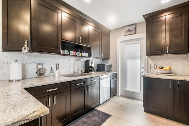 1601 SW 117th Ave, Davie, FL 33325 - kitchen with tasteful backsplash, dark brown cabinets, light stone countertops, stainless steel dishwasher, and a sink