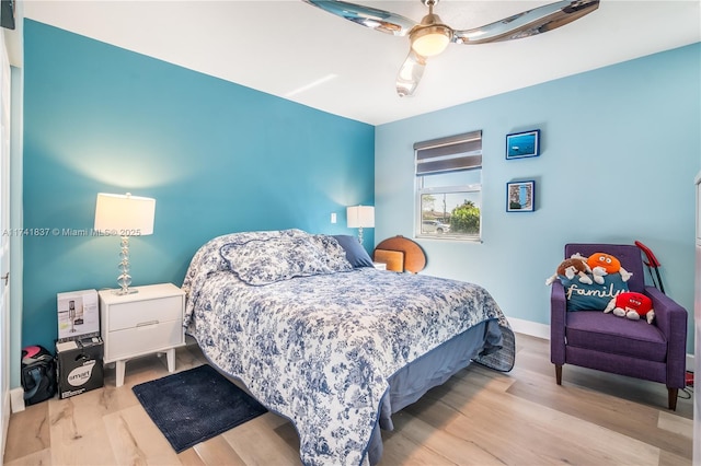 bedroom with ceiling fan and light hardwood / wood-style floors