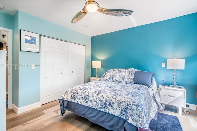 bedroom featuring ceiling fan, a closet, and light wood-type flooring