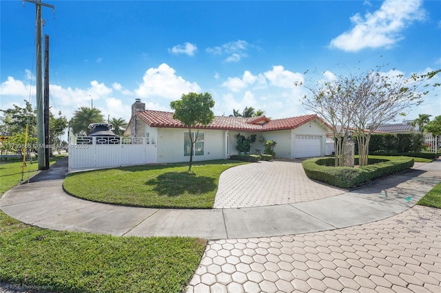 view of front of house featuring a garage and a front lawn