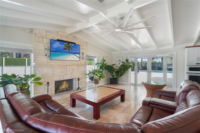 living room featuring french doors, ceiling fan, a fireplace, and lofted ceiling with beams