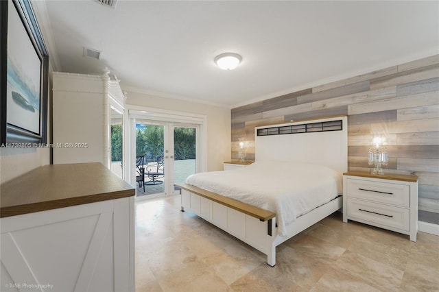 bedroom with crown molding, access to outside, wood walls, and french doors