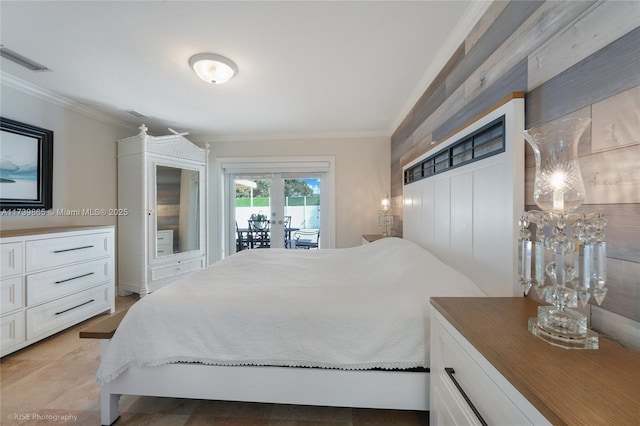 bedroom featuring french doors, crown molding, and access to outside