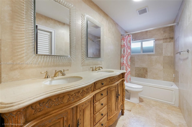 full bathroom featuring vanity, shower / bath combination with curtain, and toilet